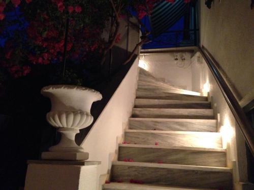 a set of stairs with a vase on them at Piteoussa in Hydra
