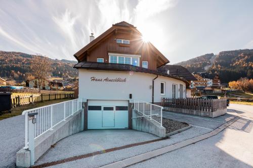 a house with a garage in front of a mountain at Penthouse Aineckblick in Sankt Margarethen im Lungau