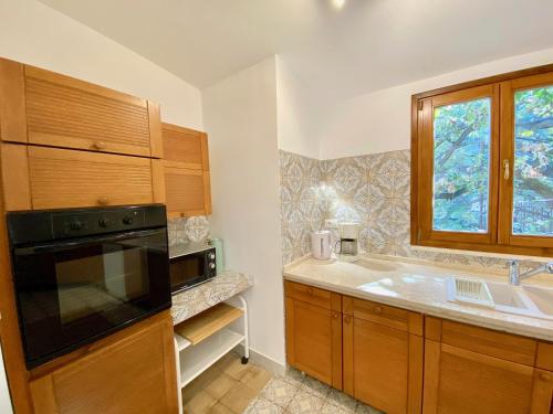 a kitchen with a sink and a microwave at Villa Don Giovanni Taormina Mare in Taormina