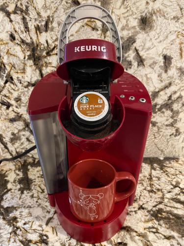 a red coffee maker with a cup of coffee at Scenic Lake View Home in Tacoma