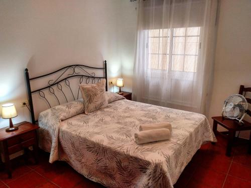 a bedroom with a large bed and a window at Apartamentos Isora in Frontera