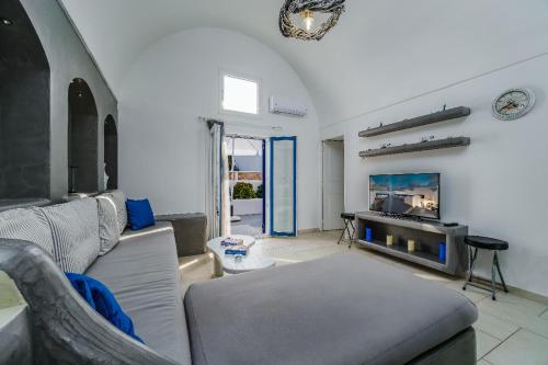 ein Wohnzimmer mit einem Sofa und einem Kamin in der Unterkunft Casa Maritina private residence in Fira