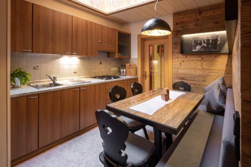 a kitchen with a wooden table and chairs at Marenklhof in Tesido