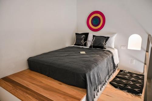 a bedroom with a bed with a black blanket at Casa Kali by Barrio México in Guadalajara