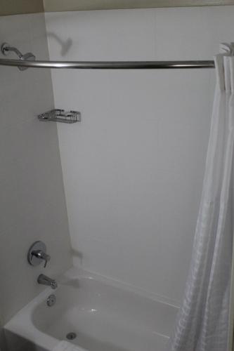 a bathroom with a shower curtain and a tub at Comfort Inn Laurinburg in Laurinburg