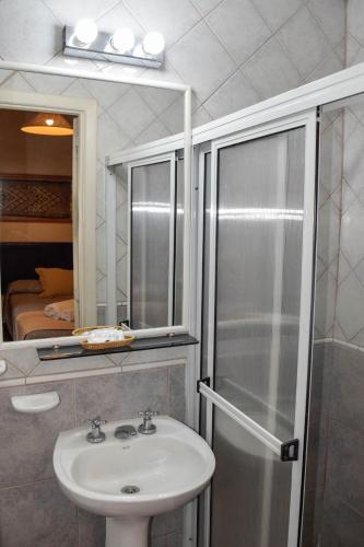 a bathroom with a sink and a shower at Hotel Nordico in San Carlos de Bariloche