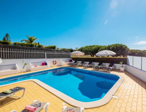 uma piscina com mobiliário de pátio e uma piscina em Villa Grace Bay by Algarve Vacation na Guia