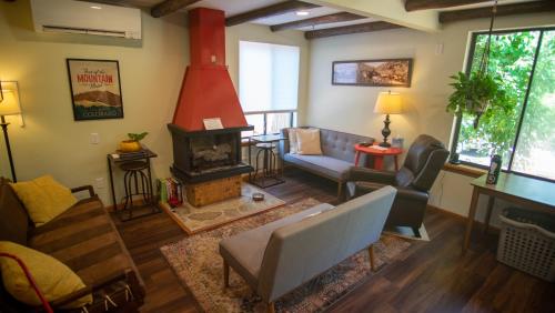 a living room with a couch and a fireplace at Foot of the Mountain Motel in Boulder