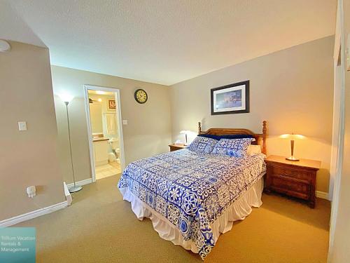 a bedroom with a bed and a clock on the wall at Classy Mountainside Studio in Blue Mountains