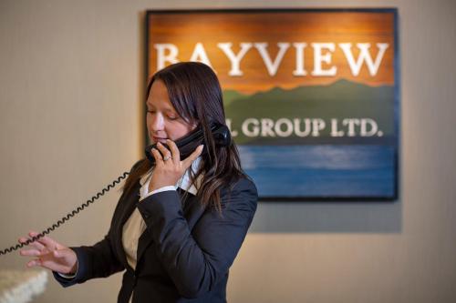 a woman talking on a cell phone at Bayview Hotel in Courtenay