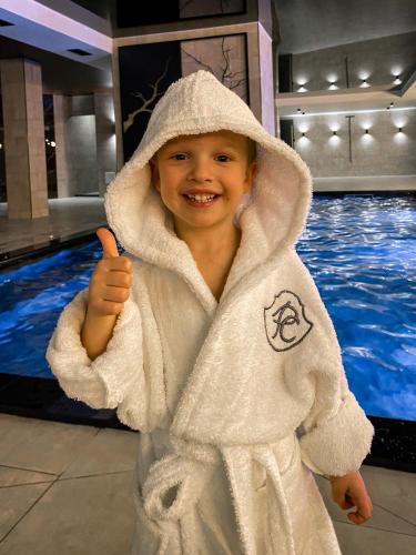 a young boy dressed in a white towel at Premium Club SPA in Bukovel