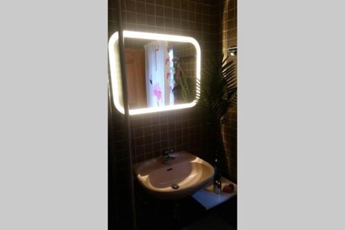 a bathroom with a sink and a mirror at Chalet BANULARA Platz für 14 Personen auf drei Etagen in Bellwald