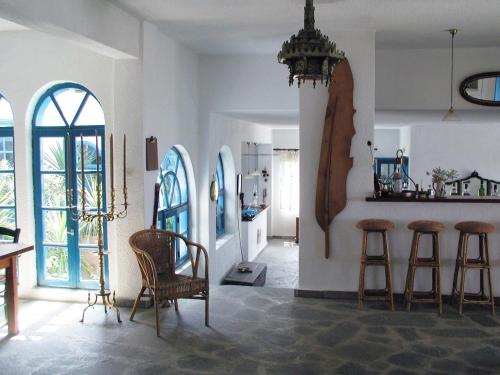 a room with chairs and a table and some windows at Skites Hotel Bungalows in Ouranoupoli