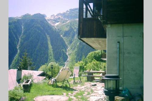 a chair sitting on a hill with a view of a mountain at Chalet BANULARA Platz für 14 Personen auf drei Etagen in Bellwald