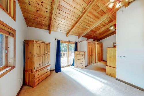 a large room with wooden ceilings and wooden cabinets at Northwoods Dream Retreat in Whitefish