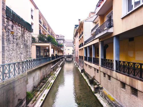 a canal in an alley between two buildings at Atipik Hôtel in Annecy