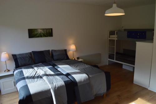 a bedroom with a bed with a striped comforter at Piano Annaberg Apartments in Annaberg