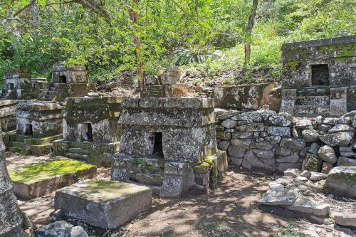 an old stone building with trees in the background at Rancho Hotel El Carmen in Tlapacoyan