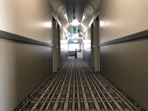 an empty hallway in an office building with a green light at Ameri-Stay Inn & Suites in Clearfield