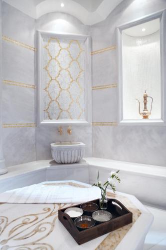a bathroom with a bath tub and a sink at Marigold Thermal & Spa Hotel Bursa in Bursa