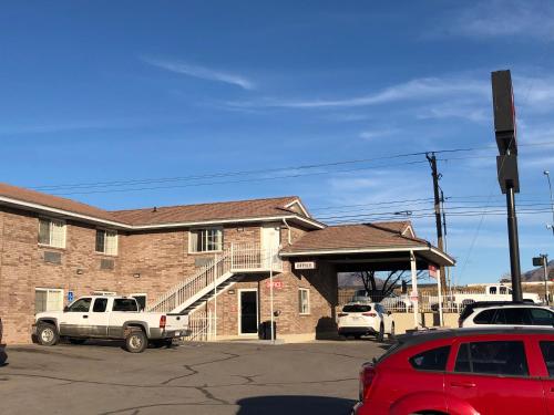 a building with cars parked in a parking lot at Ameri-Stay Inn & Suites in Clearfield