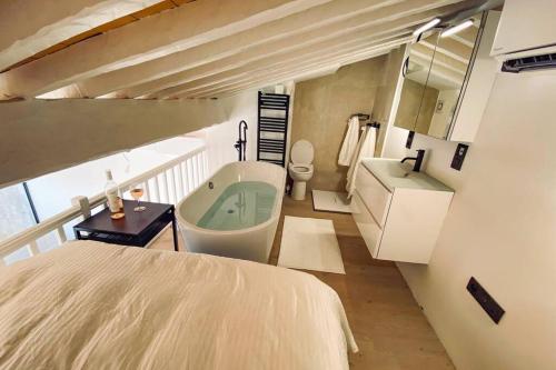 La salle de bains est pourvue d'un lit, d'un lavabo et d'une baignoire. dans l'établissement Luxe Penthouse Les Pieds dans l’eau Saint-Tropez 4, à Cogolin