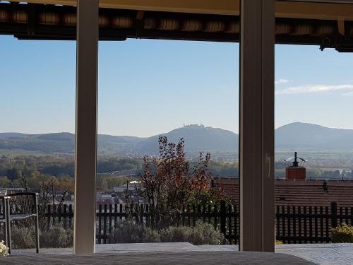 a view of the mountains from a room with windows at Blick über Krems mit Terrasse in Krems an der Donau