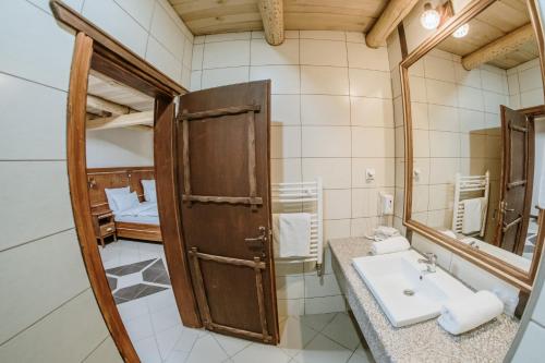a bathroom with a sink and a mirror at Etno hotel Balasevic Rtanj in Boljevac