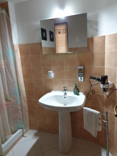 a bathroom with a white sink and a shower at Alba central City in Palermo