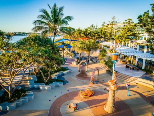 a beach with palm trees and palm trees at Salt Yeppoon in Yeppoon