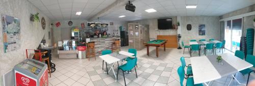 a restaurant with tables and chairs in a room at Camping les Lavandes, Castellane in Castellane
