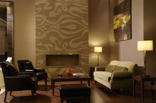 a living room with a couch and a tv at Marigold Thermal & Spa Hotel Bursa in Bursa