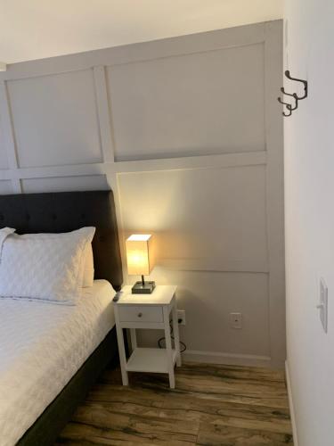 a bedroom with a bed and a nightstand with a lamp at The Brooks Hotel Restaurant and Lounge in Wallace