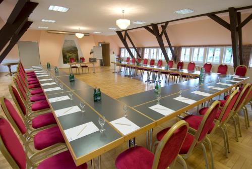a large conference room with a long table and chairs at Land- und Golfhotel Alte Fliegerschule in Eisenach