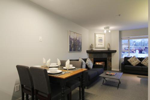 a living room with a table and a couch at Marketplace Lodge by Whistler Retreats in Whistler