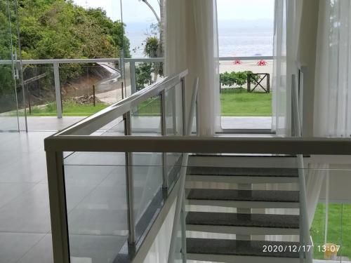 a staircase in a house with a view of the ocean at Pousada Cantinho da Praia in Paraty