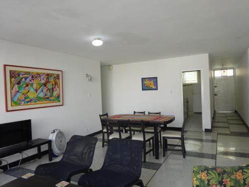 a dining room with a table and chairs in a room at OUR Place 2 in San Andrés