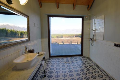 a bathroom with a sink and a large window at Mt Cook Lakeside Retreat in Lake Pukaki
