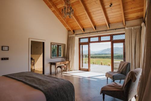 a bedroom with a bed and a table and chairs at Mt Cook Lakeside Retreat in Lake Pukaki