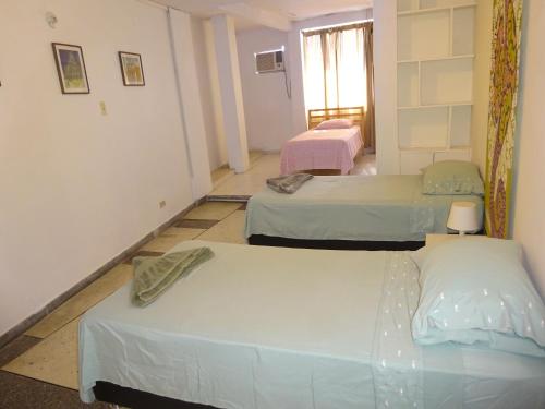 a room with three beds in a room at OUR Place 2 in San Andrés