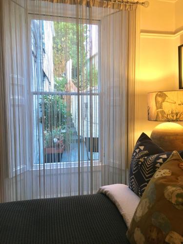 a bedroom with a window with a view of a yard at 'the inlet' falmouth in Falmouth