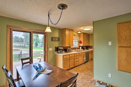 a kitchen with a table and a dining room at Rapid City Home - Walk to Canyon Lake Park in Rapid City
