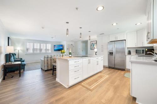 a kitchen with white cabinets and a dining room at Casablanca Inn in San Clemente