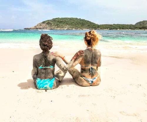 two people sitting on the beach at Ellen Bay Inn in Saint Philips