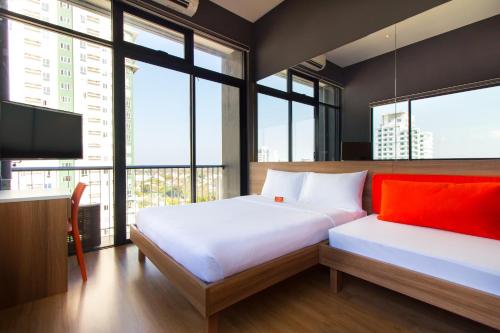 a bedroom with two beds and a flat screen tv at Azumi Boutique Hotel in Manila