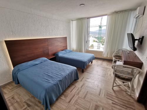 Giường trong phòng chung tại 62 ROOM PENINSULA CAPITAN