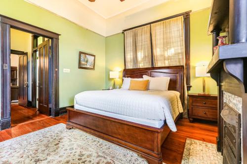 a bedroom with a bed and a fireplace at Canal Street Inn in New Orleans