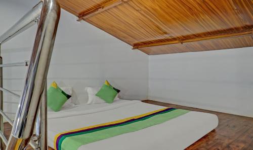a bed in a room with a wooden ceiling at Hotel Lake Paradise Mahabaleshwar in Mahabaleshwar