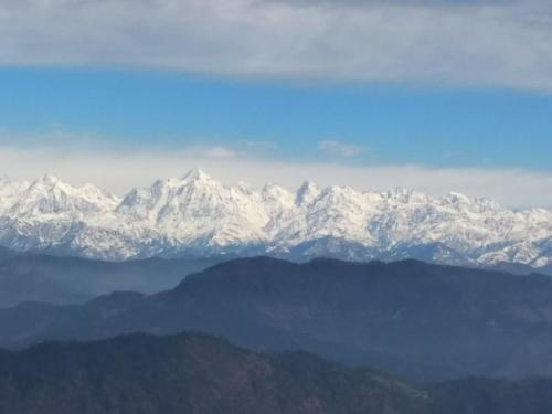 a view of snow covered mountains in the distance at Maa Anand Mayee Guest House in Panuānaula