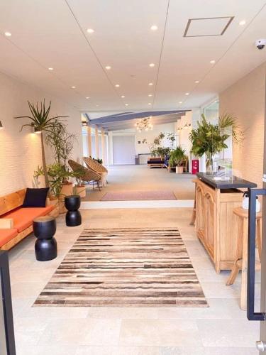 a lobby with a lot of plants in a building at Chikura Tsunagu Hotel in Minamiboso